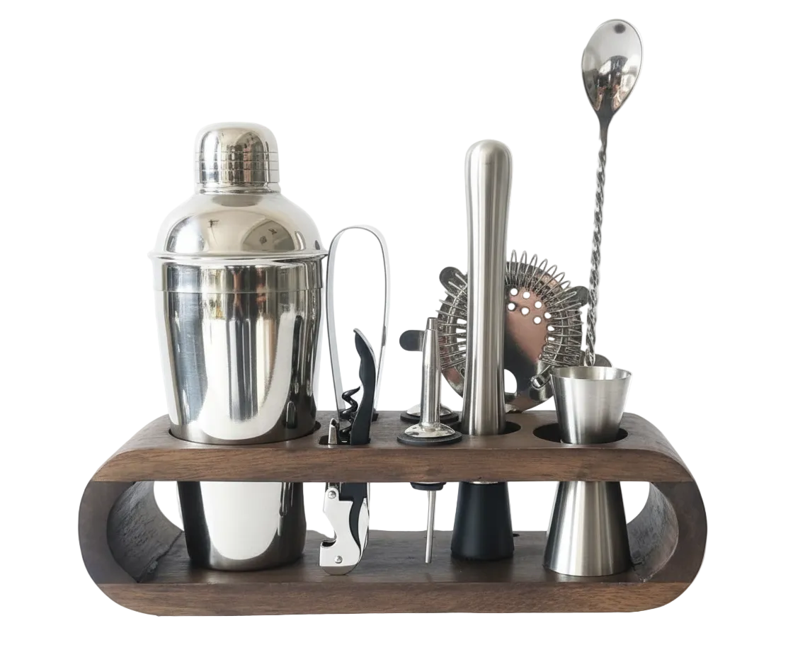 Bartender tool set with metallic shaker and tools on a wooden stand against a white background