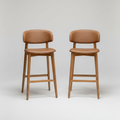 Two brown bar stools on a white background